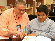Teacher in the Library working with student